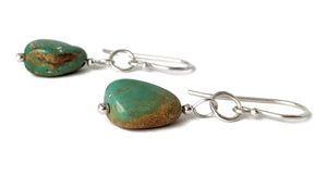 A pair of Kingman turquoise and Sterling Silver earrings in the Danare Designs jewelry Studio.