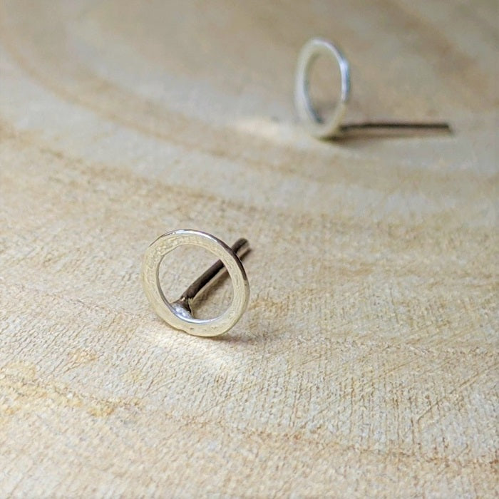 Sterling silver stud earrings site on the workbench at the Danare Designs studio.